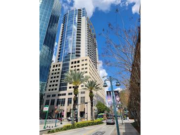 Modern high rise building with ground level landscaping on sunny day at 155 S Court Ave # 2106, Orlando, FL 32801