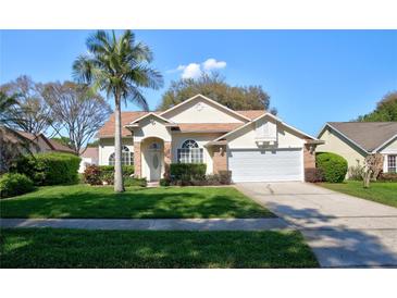 Charming single-story home featuring a lush green lawn and a well-maintained front yard with mature landscaping at 304 Silver Pine Dr, Lake Mary, FL 32746