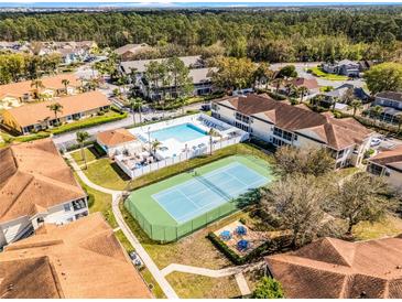 Resort-style living with a pool, spa, and tennis court surrounded by well-maintained landscaping and lush trees at 3208 Sabal Palms Ct # A, Kissimmee, FL 34747