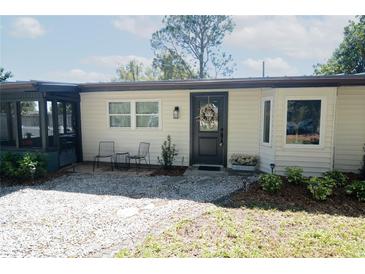 Charming home featuring a decorative wreath, a cozy seating area, and well-maintained landscaping at 3708 Merryweather Dr, Orlando, FL 32812