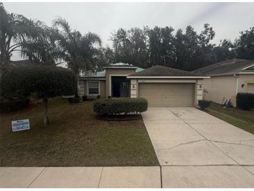 Charming single-story home featuring a well-maintained lawn and a two-car garage at 3719 Madbury Cir, Lakeland, FL 33810