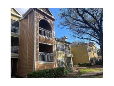 Multi-story condo building with balconies and manicured landscaping offering a desirable residential setting at 5105 City St # 817, Orlando, FL 32839