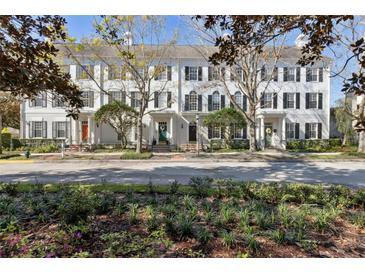 Charming townhomes boast a classic design, featuring a manicured lawn and tree-lined street at 520 Longmeadow St, Celebration, FL 34747