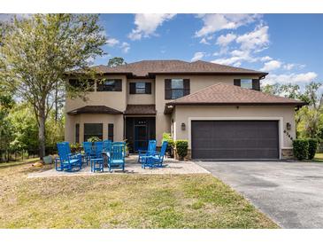 Stately two-story home featuring a charming front yard and a spacious two-car garage at 6346 Dallas Blvd, Orlando, FL 32833