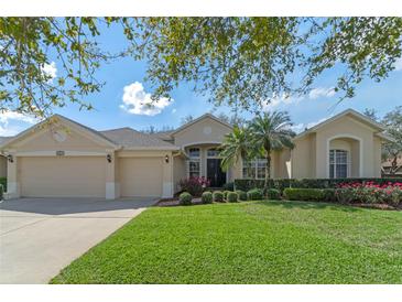 Charming home featuring a three-car garage, well-maintained lawn, and lush landscaping at 1657 Cherry Ridge Dr, Lake Mary, FL 32746