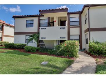 Inviting condo exterior with well-maintained landscaping and clearly marked unit numbers at 3467 Flossmoor Ave # 101, Orlando, FL 32822