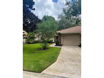 Charming single-story home with well-manicured lawn and inviting curb appeal at 417 Evesham Pl, Longwood, FL 32779