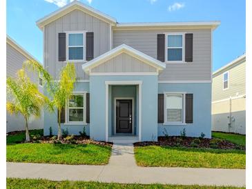 Charming two-story home featuring a welcoming entrance and beautifully landscaped front yard at 6230 Shavasana Rd, Clermont, FL 34714