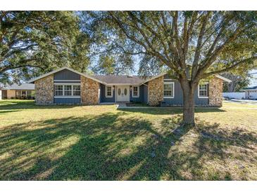 Charming single-story home with stone accents, lush lawn and mature trees at 805 Leopard Trl, Winter Springs, FL 32708