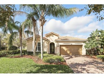 Charming single-story home with a tile roof, mature landscaping, and a brick driveway at 11866 Barletta Dr, Orlando, FL 32827