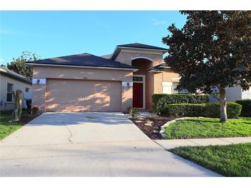Charming single-Gathering home with landscaped front yard and attached two-car garage at 1862 Great Falls Way, Orlando, FL 32824