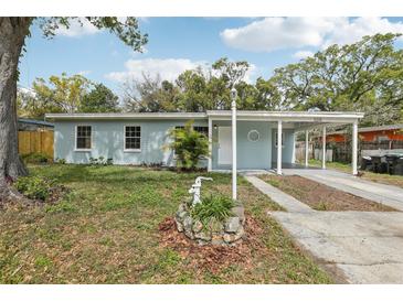 Charming one-story home with well-maintained front yard and covered carport at 5215 Ashwood Pl, Orlando, FL 32808
