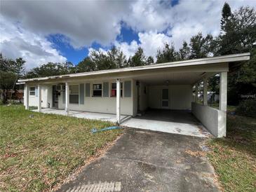 Modest single-story home features a carport, small front porch, and classic shutters at 5401 Bobby St, Orlando, FL 32807