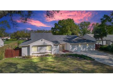 Charming single-story home with lush landscaping, manicured lawn, and a convenient three-car garage at 6735 Edgeworth Dr, Orlando, FL 32819