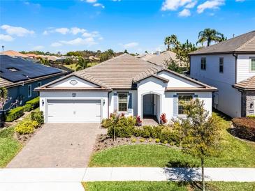 Charming single-story home featuring a well-manicured lawn and a two car garage in a sunny neighborhood at 7916 Wandering Way, Orlando, FL 32836