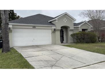 Charming single-Gathering home features a two-car garage, well-maintained landscaping, and a welcoming front entrance at 8419 Fort Thomas Way, Orlando, FL 32822