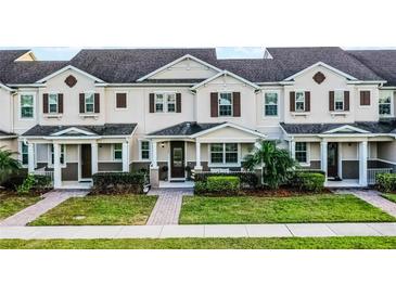 Charming two-story townhome featuring a well-manicured lawn and inviting front porch at 13727 Bressler Aly, Windermere, FL 34786