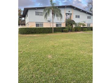 Charming two-story condo building with well-manicured lawn and privacy hedges at 1695 Lee Rd # C202, Winter Park, FL 32789