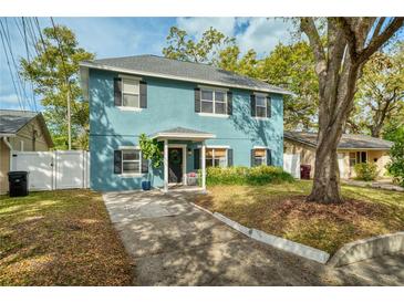 Charming blue two-story home with a welcoming front porch and well-maintained landscaping at 2504 Helen Ave, Orlando, FL 32804