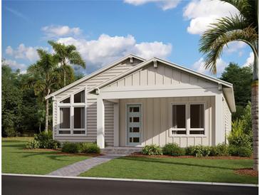 Charming single-story home with a covered front porch, well-manicured lawn, and beautiful landscaping at 2953 Sailhouse Dr, St Cloud, FL 34771