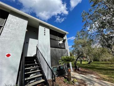 Charming two-story condo with a private balcony, surrounded by lush greenery and a well-manicured lawn at 4882 S Semoran Blvd # 1408, Orlando, FL 32822