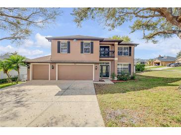 Charming two-story home featuring a three-car garage and a welcoming front yard with mature trees at 524 Quail View Ct, Debary, FL 32713