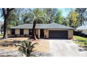 Charming single-story home with a well-maintained yard and mature landscaping and a two car garage at 5443 Aeolus Way, Orlando, FL 32808