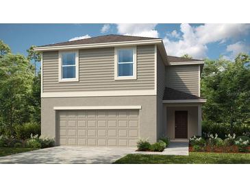 Charming two-story home featuring a two-car garage and a beautifully landscaped front yard at 7367 Capstone Dr, Groveland, FL 34736