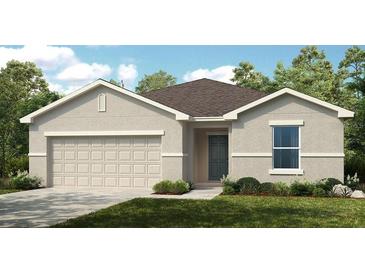 Charming single-story home with a two-car garage, lush lawn, and attractive neutral-toned facade at 7392 Capstone Dr, Groveland, FL 34736