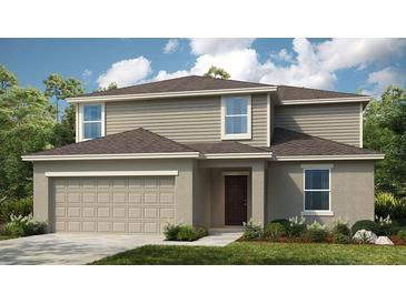 Charming two-story home featuring a neutral color palette, well-manicured landscaping and an attached two-car garage at 7404 Capstone Dr, Groveland, FL 34736