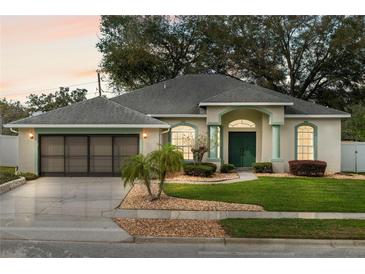 Charming one-story home with well-manicured lawn and a two-car garage at 839 High Pointe Cir, Minneola, FL 34715