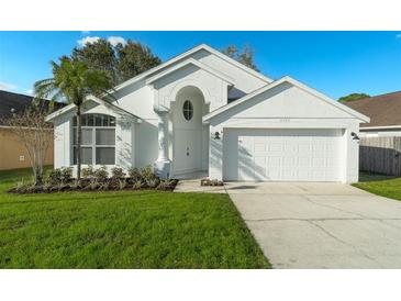 Charming single-story home featuring a well-manicured lawn, attached garage, and an attractive white facade at 2902 Egrets Landing Dr, Lake Mary, FL 32746