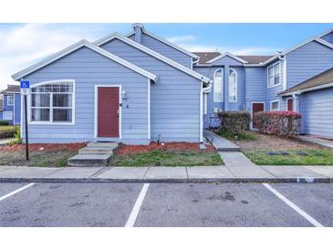 Charming townhouse featuring a light blue exterior with well-maintained landscaping at 758 Orchid Dr, Davenport, FL 33897