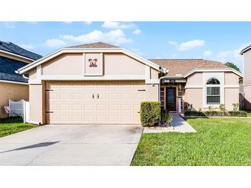 Charming single-story home with a well-maintained lawn, a two-car garage, and neutral exterior paint at 1006 Gotwalt Dr, Oviedo, FL 32765