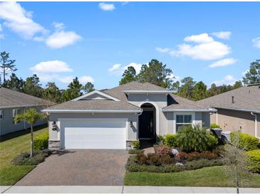 Charming single-story home featuring a brick driveway, manicured landscaping, and a welcoming front entrance at 1121 Avery Meadows Way, Deland, FL 32724
