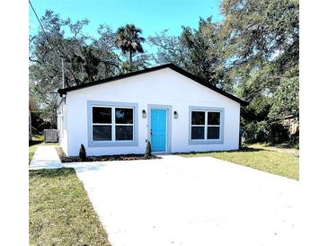 Charming single-story home featuring a modern design with a bright blue front door at 1200 Jarecki Ave, Holly Hill, FL 32117