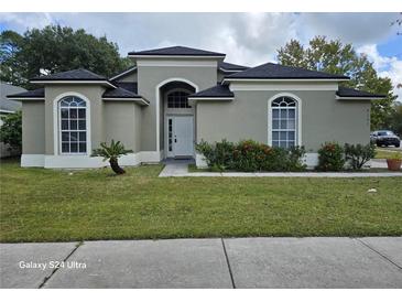 Beautiful single-story home with lush green lawn and lovely landscaping at 4151 Forest Island Dr, Orlando, FL 32826