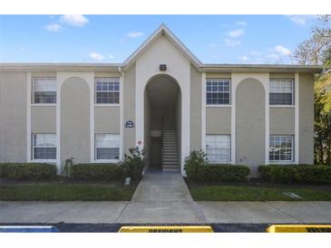 Exterior view of the condo building with well-maintained landscaping and visible unit numbers at 4300 Hector Ct # 7, Orlando, FL 32822