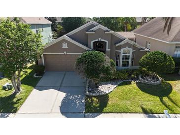 Charming single-Gathering home featuring a two-car garage and lush landscaping at 619 Blenheim Loop, Winter Springs, FL 32708