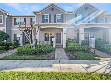 Charming townhome with a landscaped front yard and inviting entrance at 1260 Honey Blossom Dr, Orlando, FL 32824