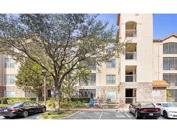 Beautiful exterior shot of a four-story building showing balconies and manicured landscaping at 1371 Tuscan Terrace # 3203, Davenport, FL 33896