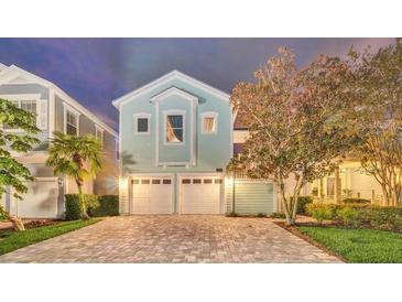 Charming two-story home with a brick driveway and two-car garage at 1427 Fairview Cir, Reunion, FL 34747