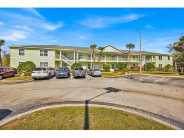 Inviting condo complex with ample parking, lush landscaping, and light green exterior at 3162 Sun Lake Ct # B, Kissimmee, FL 34747