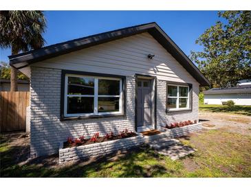 Charming home featuring fresh exterior paint, a well-manicured lawn, and beautiful curb appeal at 4452 Fairview Ave, Orlando, FL 32804