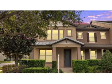 Charming two-story townhome with well-maintained landscaping and inviting front porch at 5095 Caspian St, St Cloud, FL 34771