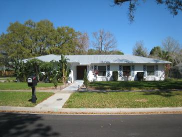 Charming single-story home with well-maintained lawn, sidewalk, and mature landscaping at 5121 Hoperita St, Orlando, FL 32812