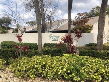 Exterior view of the Goldenrod Villas community sign surrounded by beautiful landscaping at 7706 Country Pl # 7706, Winter Park, FL 32792