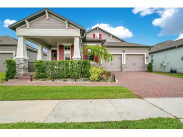 Beautiful two-story home featuring a two-car garage, manicured lawn, and brick paved driveway at 13227 Spring Grove Way, Winter Garden, FL 34787