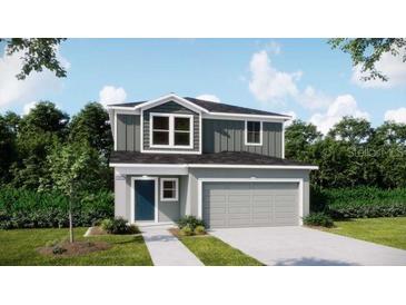 Charming two-story home with gray accents, a two-car garage, and a well-manicured lawn at 3860 Bluethread Way, Poinciana, FL 34759