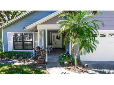Charming home featuring a welcoming front entrance with a well-manicured garden and a lovely white door at 418 S Summerlin Ave, Sanford, FL 32771